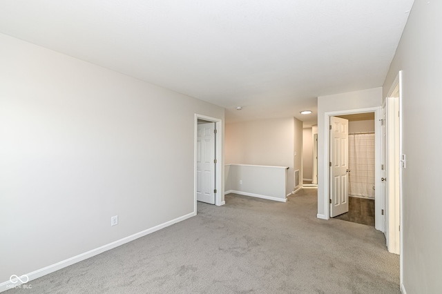 unfurnished bedroom featuring carpet flooring and baseboards