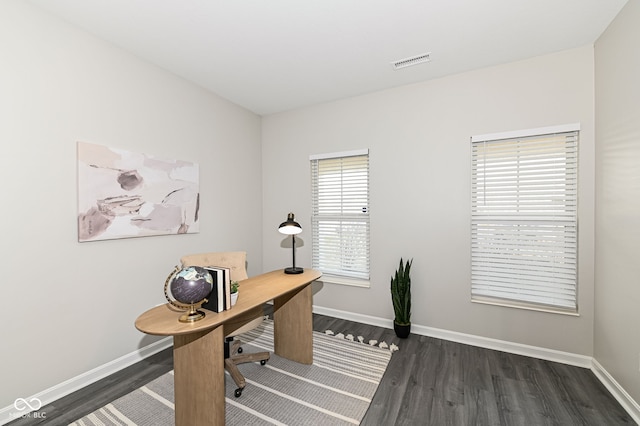 office space with visible vents, dark wood-type flooring, and baseboards