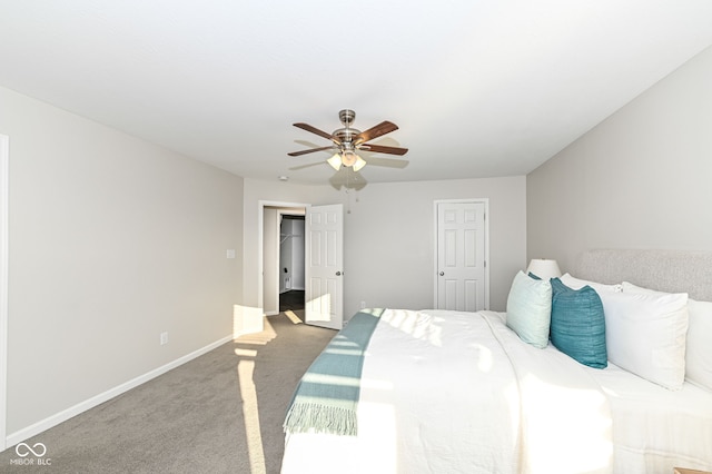 carpeted bedroom with baseboards and a ceiling fan