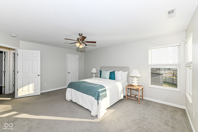 bedroom featuring visible vents, carpet flooring, baseboards, and ceiling fan