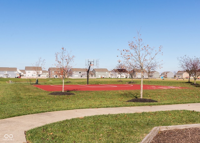 view of home's community featuring community basketball court, a lawn, and a residential view