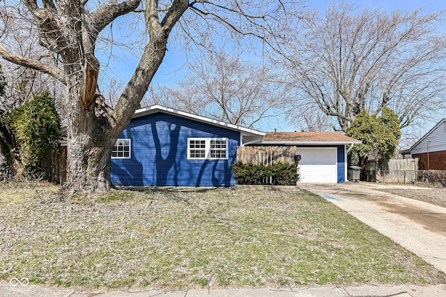 ranch-style house with concrete driveway, an attached garage, and fence