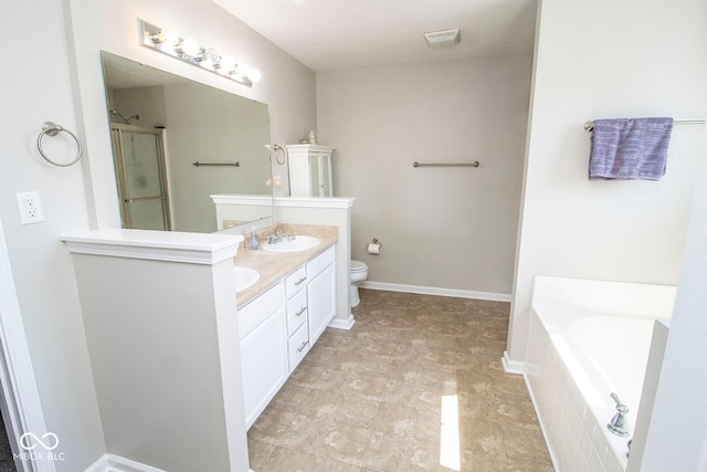 bathroom featuring a shower with shower door, a sink, double vanity, baseboards, and a bath