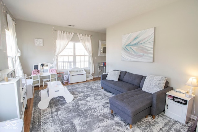 living room featuring visible vents and wood finished floors