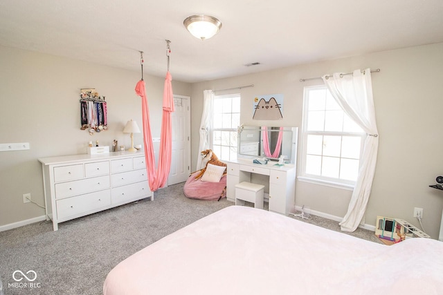 carpeted bedroom with visible vents and baseboards