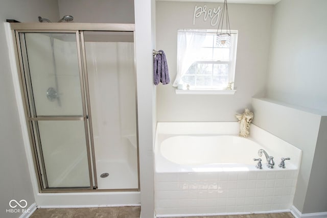 full bathroom featuring a shower stall and a garden tub