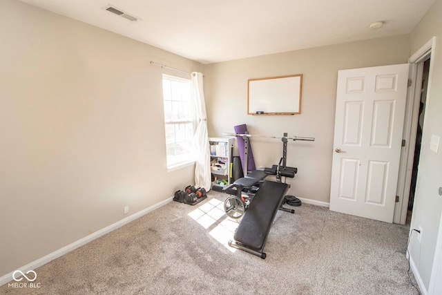 workout area featuring visible vents, baseboards, and carpet flooring