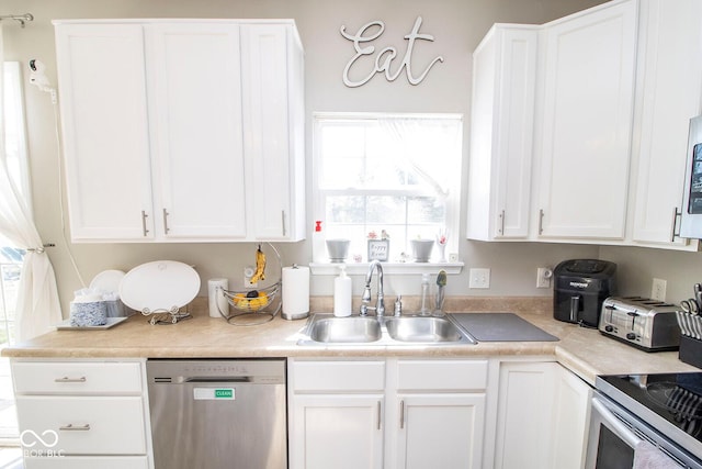 kitchen featuring a sink, stainless steel appliances, and white cabinetry