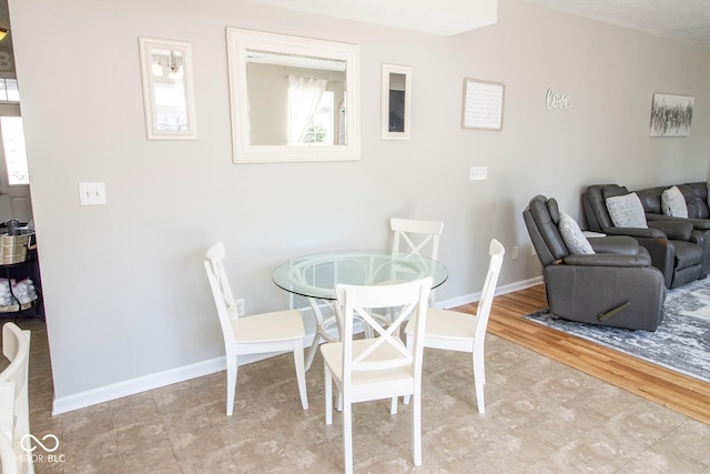 dining room with a wealth of natural light and baseboards