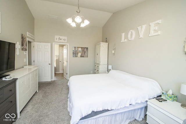 bedroom with light colored carpet, lofted ceiling, a notable chandelier, and ensuite bath