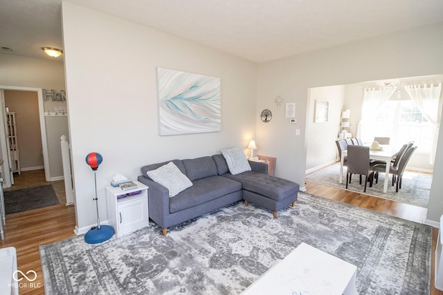 living area with baseboards and wood finished floors