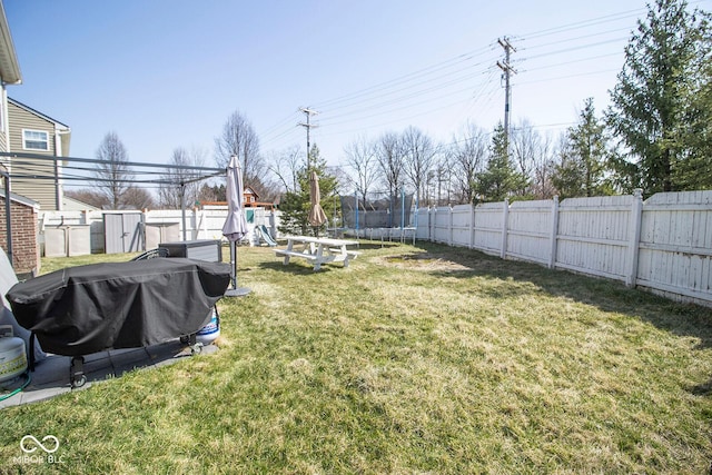 view of yard with a fenced backyard, a playground, and a trampoline