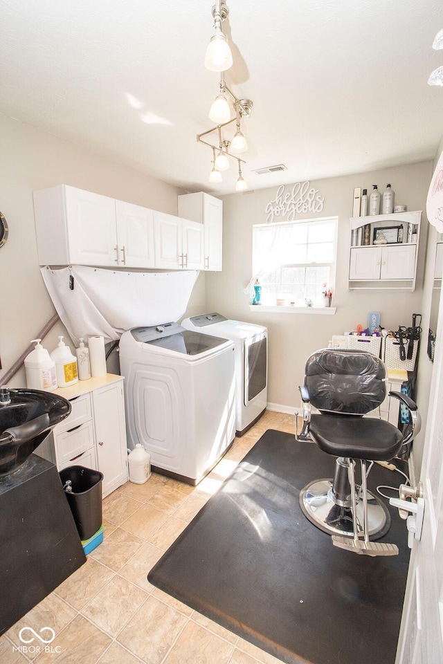 washroom with washing machine and clothes dryer, visible vents, light tile patterned floors, cabinet space, and a sink