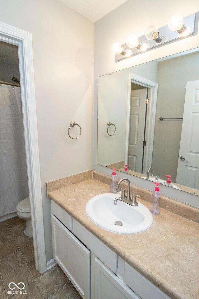 bathroom featuring toilet and vanity