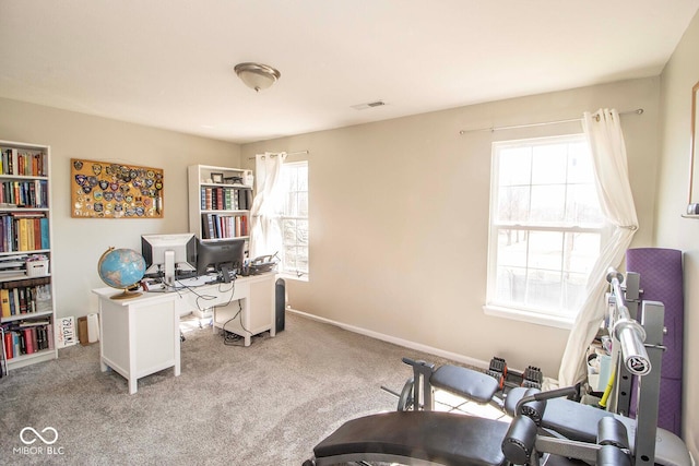 home office with carpet flooring, a healthy amount of sunlight, baseboards, and visible vents