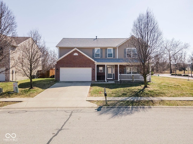 traditional home featuring brick siding, an attached garage, a front yard, covered porch, and driveway