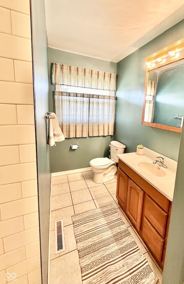 bathroom with tile patterned floors, visible vents, toilet, and vanity