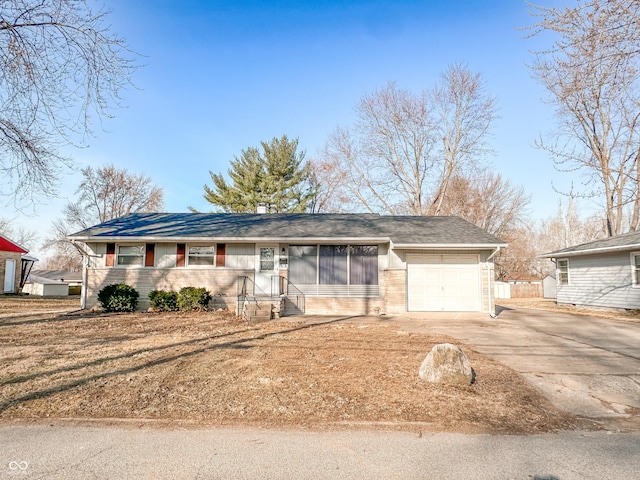 ranch-style home with driveway and an attached garage