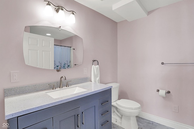 full bath featuring vanity, toilet, baseboards, and marble finish floor