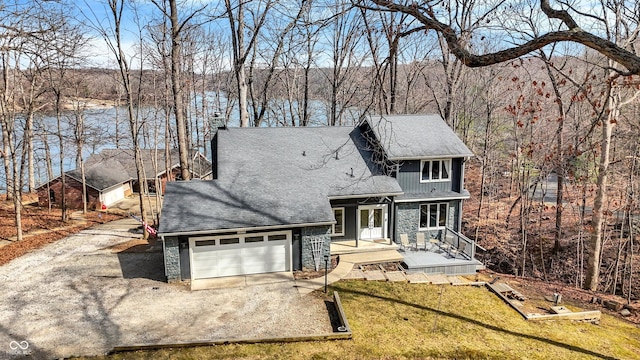 rustic home with a garage, stone siding, driveway, and a shingled roof