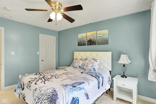 bedroom featuring baseboards, carpet floors, and a ceiling fan