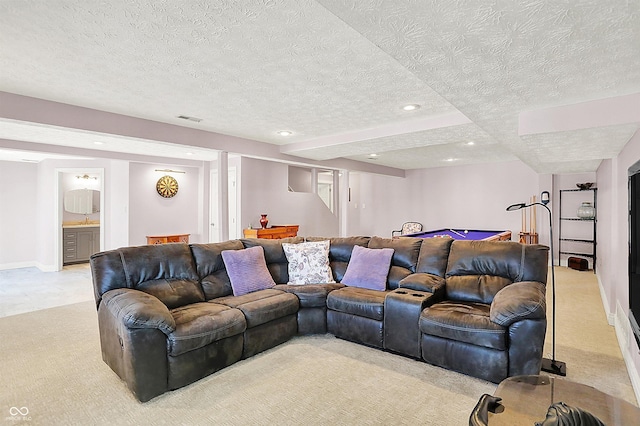 living room featuring visible vents, light carpet, a textured ceiling, recessed lighting, and baseboards