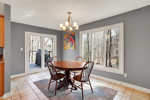 dining area featuring a notable chandelier, plenty of natural light, visible vents, and light tile patterned floors