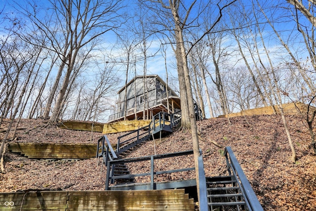 view of yard with an outdoor structure, stairway, and a barn