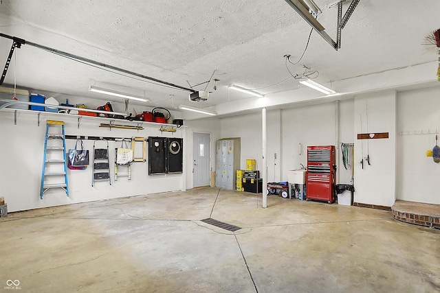 garage featuring a sink and a garage door opener