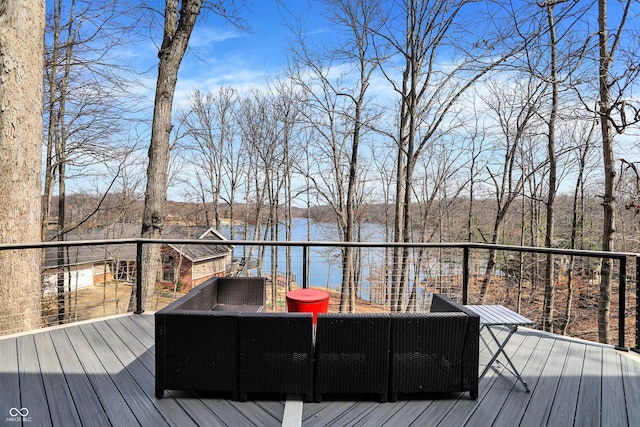 wooden terrace featuring an outdoor living space and a water view