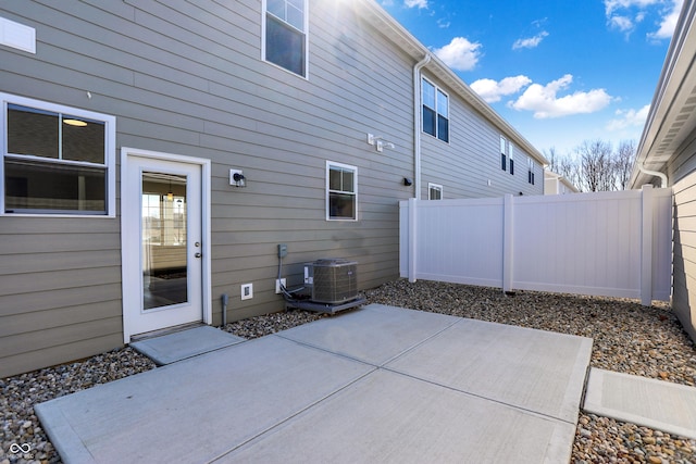 exterior space featuring central AC unit and fence