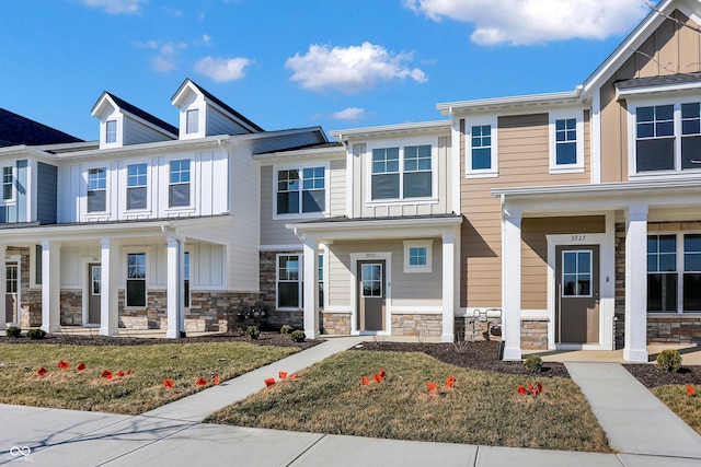 townhome / multi-family property featuring stone siding and board and batten siding