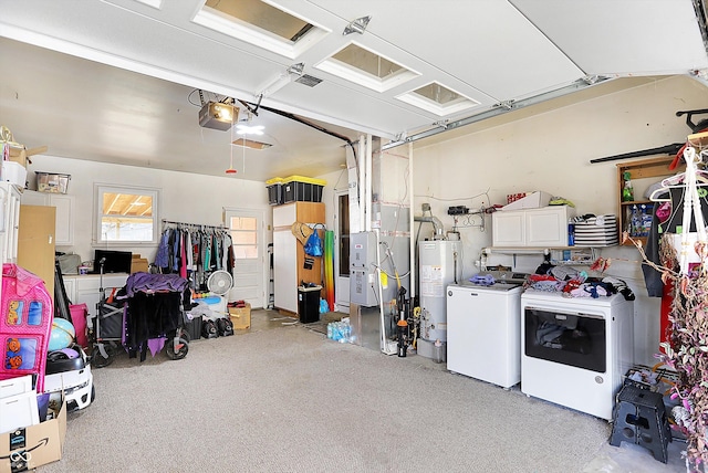 garage with gas water heater, a garage door opener, and separate washer and dryer