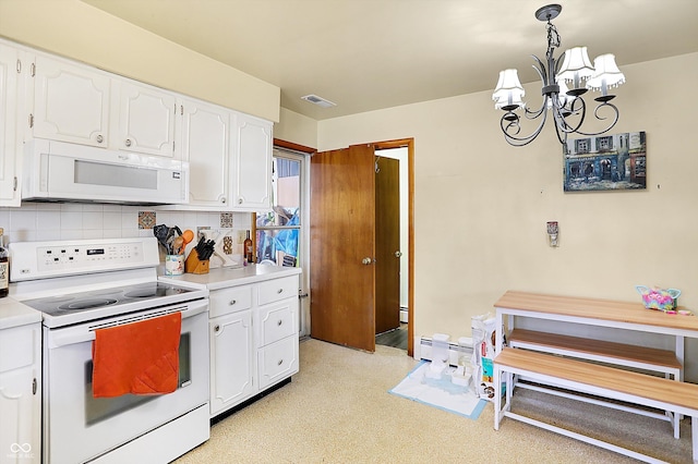 kitchen featuring white appliances, visible vents, light countertops, white cabinetry, and a notable chandelier