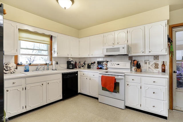 kitchen with decorative backsplash, white cabinets, white appliances, and a sink