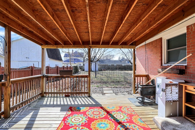 wooden deck featuring a fenced backyard