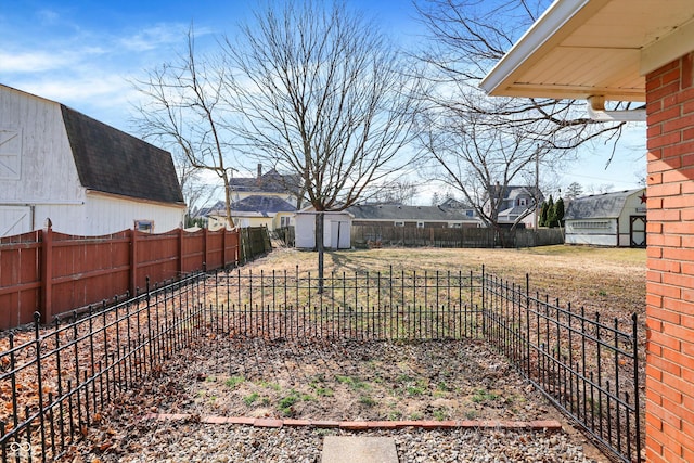 view of yard featuring a fenced backyard, an outdoor structure, and a shed