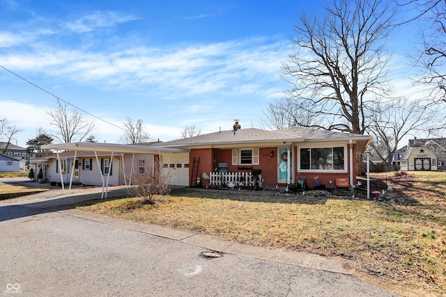 ranch-style house with brick siding, a front yard, covered porch, a carport, and an attached garage