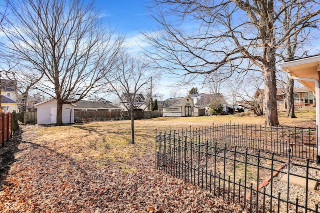 view of yard featuring an outbuilding, fence private yard, and a shed