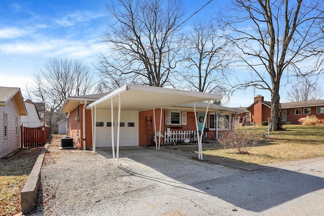 view of front of home featuring brick siding, an attached garage, covered porch, a carport, and driveway