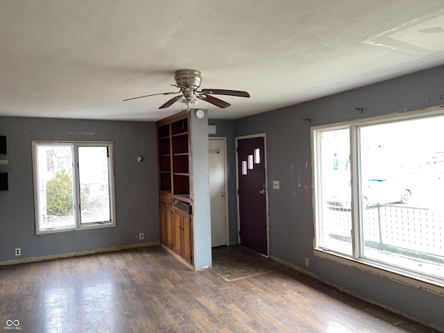 foyer entrance with wood finished floors, baseboards, and ceiling fan