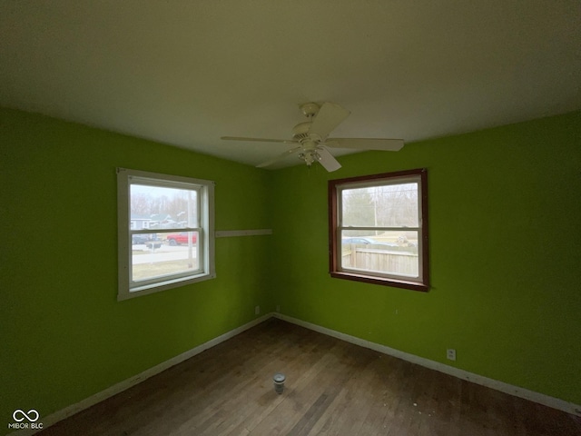 unfurnished room featuring ceiling fan, baseboards, and wood finished floors