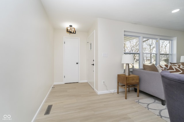 entrance foyer featuring baseboards, visible vents, an inviting chandelier, recessed lighting, and light wood-style floors