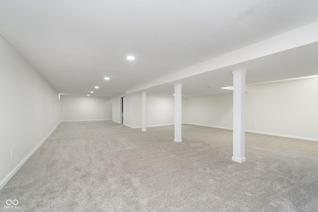 finished basement featuring recessed lighting, baseboards, and light carpet