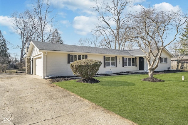 ranch-style house featuring brick siding, an attached garage, concrete driveway, and a front yard