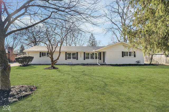 back of house featuring a yard and fence