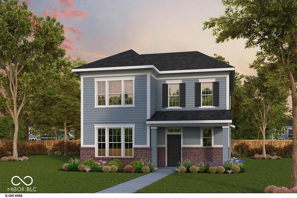 view of front of house with brick siding, a front yard, and fence