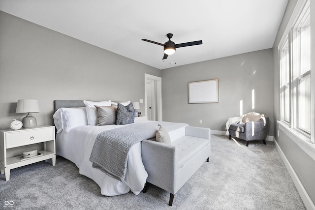 carpeted bedroom featuring ceiling fan and baseboards