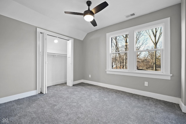 unfurnished bedroom featuring vaulted ceiling, carpet, visible vents, and baseboards