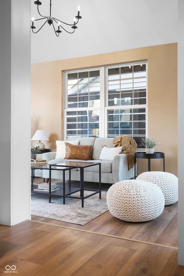 interior space featuring wood finished floors and a chandelier